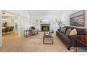Inviting living room featuring a fireplace, neutral carpeting, and stylish, comfortable furnishings at 7190 S Poplar Ct, Centennial, CO 80112