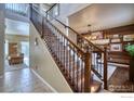 Elegant staircase with decorative iron railings and wood treads, leading to the upper level at 9018 Harlequin Cir, Frederick, CO 80504