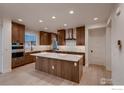 Modern kitchen with a large island, stainless steel appliances, and custom wood cabinets at 935 Eldorado Ln # A, Louisville, CO 80027