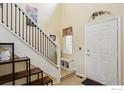 Welcoming foyer boasts a staircase, bench, and shoe storage for added convenience and organization at 109 Huntley Creek Ct, Erie, CO 80516