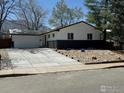 Beautiful single-Gathering home with a large driveway leading to the attached garage at 1225 Ithaca Dr, Boulder, CO 80305