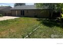 A spacious backyard featuring a patio area and ample green space for outdoor activities at 12820 Dexter St, Thornton, CO 80241