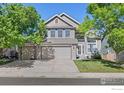 Traditional two-story home with three-car garage, well-maintained lawn and beautiful curb appeal at 13311 Pearl Cir, Thornton, CO 80241