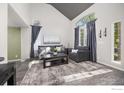 Bright living room with vaulted ceiling, large windows, and stylish decor at 13311 Pearl Cir, Thornton, CO 80241