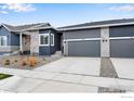 Charming home exterior with well-manicured landscaping and a two-car garage with driveway at 1760 Mount Meeker Ave, Berthoud, CO 80513