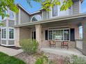 Charming front porch with brick accents and a cozy seating area, welcoming guests to the home at 2248 Imperial Ln, Superior, CO 80027