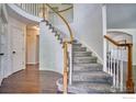 Beautiful foyer with a curved staircase featuring wood railing and plush carpet, creating an elegant entryway at 2248 Imperial Ln, Superior, CO 80027