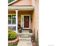 Inviting front entrance featuring a charming porch and a decorative wreath on the door at 301 Widgeon Ln, Longmont, CO 80503