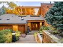 Inviting front entrance with custom wood door, elegant lighting, and well-maintained landscaping at 3746 Wonderland Hill Ave, Boulder, CO 80304