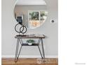 Hallway with decorative hairpin table, mirror, and plants for staging purposes at 4035 Darley Ave, Boulder, CO 80305