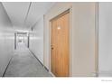 Long hallway with carpet and view of the corridor near a door with a unit number at 4110 Hale Pkwy # 5F, Denver, CO 80220