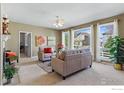 Cozy living room features large windows, plush seating, and neutral tones for a relaxing atmosphere at 5017 Bella Vista Dr, Longmont, CO 80503