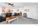 Spacious living room with carpet, a ceiling fan, and a dedicated desk/office area at 5425 County Road 32 # 27, Mead, CO 80504