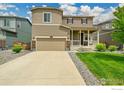 Charming two-story home with a well-maintained lawn and welcoming front porch at 6008 Sandstone Cir, Frederick, CO 80516