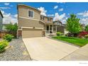 Charming two-story home with a well-maintained lawn and welcoming front porch at 6008 Sandstone Cir, Frederick, CO 80516
