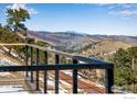 View from the deck overlooking treed landscape and rolling mountains, offering a tranquil escape and spectacular view at 6465 Red Hill Rd, Boulder, CO 80302