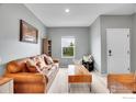 Cozy living room featuring a comfortable sofa, stylish decor, and ample natural light at 7306 Ellingwood Cir, Frederick, CO 80504