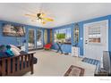 A comfortable living room featuring stylish decor, neutral carpet, and beach-themed artwork at 902 Pacific Pl, Fort Lupton, CO 80621