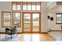 Bright living room featuring a vaulted ceiling, large windows, and access to an outdoor deck at 990 Utica Cir, Boulder, CO 80304