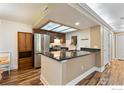 Bright kitchen with stainless steel appliances, breakfast bar, and eat-in dining area at 10890 W Evans Ave # 1G, Lakewood, CO 80227