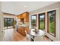 Cozy kitchen with breakfast nook, natural wood cabinets, and views of the lush landscape at 1101 Peakview Cir, Boulder, CO 80302