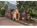 Charming brick home with a well-manicured lawn, a welcoming front porch, and stone pathway at 1133 Mapleton Ave, Boulder, CO 80304