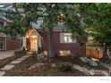 Lovely brick home featuring a well-kept lawn, charming walkway, and a cozy front porch at 1133 Mapleton Ave, Boulder, CO 80304