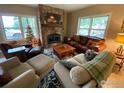Cozy living room featuring a stone fireplace and comfortable seating arrangement at 1555 Three Peaks Rd, Golden, CO 80403