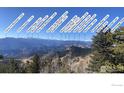 Panoramic mountain view with labeled peaks showing the landscape around the property at 1555 Three Peaks Rd, Golden, CO 80403