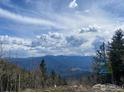 Scenic mountain view with layered clouds over the horizon from the property at 1555 Three Peaks Rd, Golden, CO 80403