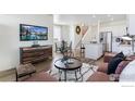 Inviting open-concept living area showcasing modern furnishings and a seamless flow to the kitchen at 18714 E 99Th Ave, Commerce City, CO 80022