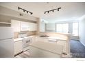 Kitchen featuring white appliances, an island, and views into the living room at 2162 Concord Ln, Superior, CO 80027