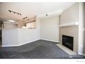 Cozy living room featuring a fireplace, neutral paint, and carpet at 2162 Concord Ln, Superior, CO 80027