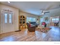 Spacious living room with hardwood floors, large windows, and comfortable seating at 2417 Calais Dr # 19 D, Longmont, CO 80504