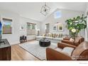 Bright and airy living room featuring a vaulted ceiling, large windows, and stylish modern furnishings at 2917 13Th St, Boulder, CO 80304