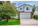 Charming two-story home featuring a brick facade and a well-manicured front yard at 2940 E Yarrow Cir, Superior, CO 80027