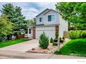 Charming two-story home with a brick facade and a lush green lawn at 2940 E Yarrow Cir, Superior, CO 80027