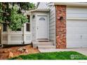 Inviting front door with brick accents and manicured landscaping at 2940 E Yarrow Cir, Superior, CO 80027