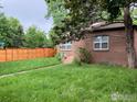 Well-maintained yard featuring lush green grass and a sturdy wooden fence for privacy and security at 3201 Broadway St, Boulder, CO 80304