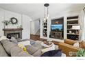 A cozy living room features built-in shelves, a fireplace, and stylish, comfortable furnishings at 4109 Frederick Cir, Longmont, CO 80503