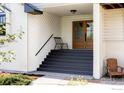 Charming front porch with well-maintained steps leading to a beautiful glass-paneled entry door and stylish seating at 4932 Valkyrie Dr, Boulder, CO 80301