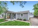 Charming home with an inviting facade and detached garage at 6825 Reno Dr, Arvada, CO 80002