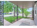 View from the covered front porch with decorative metal supports at 6825 Reno Dr, Arvada, CO 80002