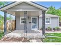 Inviting covered porch showcasing decorative metal supports at 6825 Reno Dr, Arvada, CO 80002