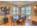 Inviting dining room showcasing a wood table, six windows, and hardwood flooring at 705 Rawlins Way, Lafayette, CO 80026