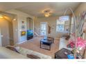 Cozy living room with carpet, neutral walls, and comfortable seating arrangement at 705 Rawlins Way, Lafayette, CO 80026