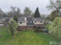 A bird's eye view of the backyard featuring a well-maintained lawn and covered patio at 7505 Estate Cir, Niwot, CO 80503