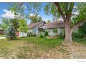 Inviting ranch-style home with a charming front porch, mature landscaping and great curb appeal at 8200 S Locust Way, Centennial, CO 80112
