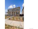 Two-story home exterior with stone accents and walkway at 9857 Biscay St, Commerce City, CO 80022