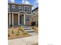 Open floor plan of the living room and kitchen with gray cabinets at 9857 Biscay St, Commerce City, CO 80022